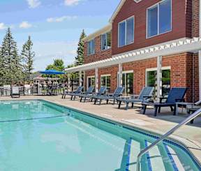 A 4ft pool outside a brick and red building
