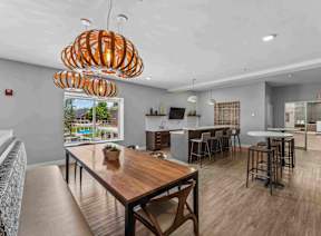 A modern kitchen with a wooden table and chairs.