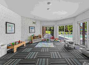 A room with a grey carpet and a white ceiling.