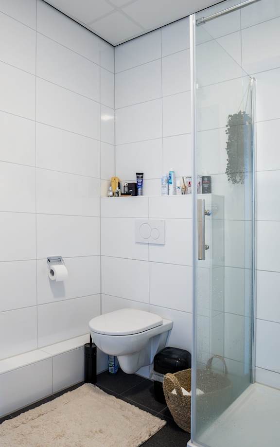 a white bathroom with a sink and a toilet