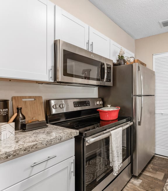 a kitchen with stainless steel appliances and granite counter tops