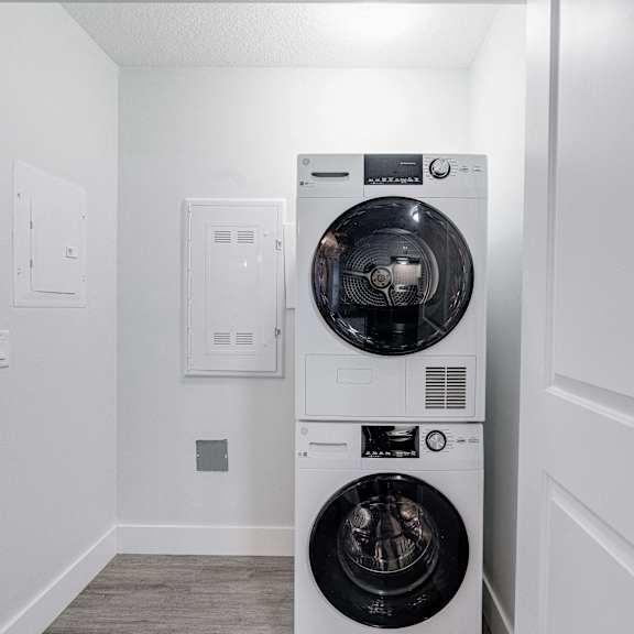 A white washing machine and dryer in a laundry room.