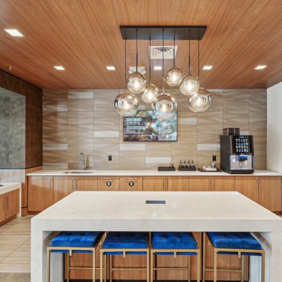 a large kitchen with a marble counter top and wooden cabinets