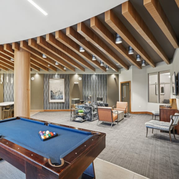 a clubhouse with a pool table and a living room