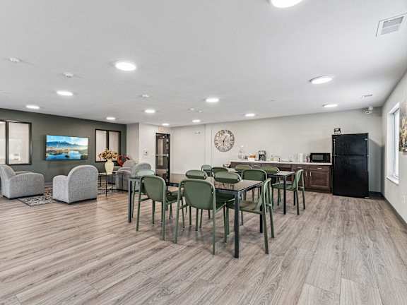a dining room and living room with a table and chairs