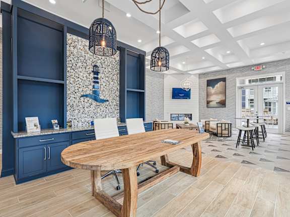 A modern dining area with a wooden table and chairs.at The Parker Leland, Leland
