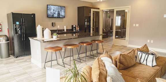 A modern living room with a bar area and a television.