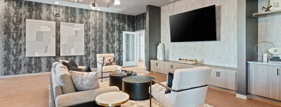 a living room with couches and chairs and a tv