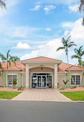 a house with palm trees in front of it at Bay Breeze Villas, Fort Myers, FL, 33908