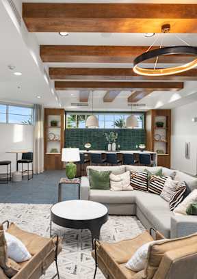 A modern living room with a fireplace and a flat screen TV mounted on the wall.