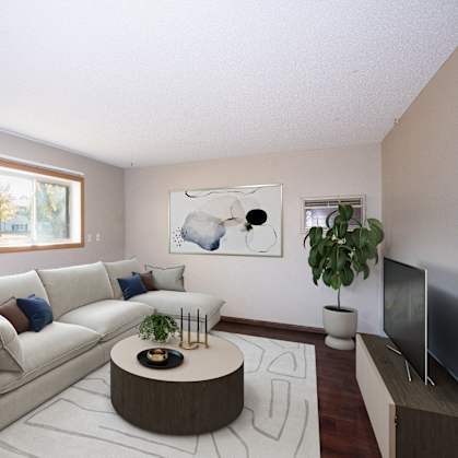 a living room with a white couch and a round coffee table.  Fargo, ND Country Club Apartments