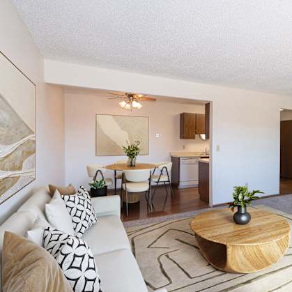 a living room with a couch and a table and a tv. Fargo, ND Hartford Apartments