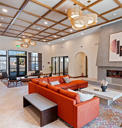 A living room with a fireplace and a painting on the wall.