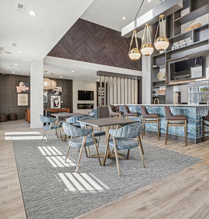 A modern dining room with a large table and chairs.