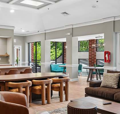 A modern kitchen with a dining table and chairs.