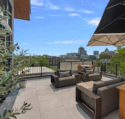 A patio with furniture and a view of a city skyline.