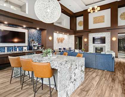 A modern kitchen with a bar area and a dining table.