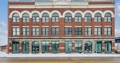 A red brick building with a white sign on the top.