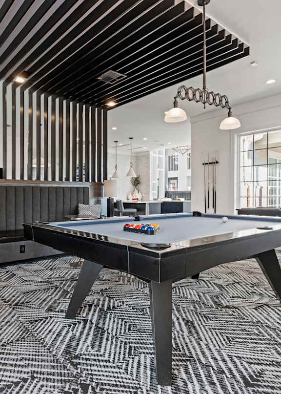 A modern dining room with a large table and chairs.