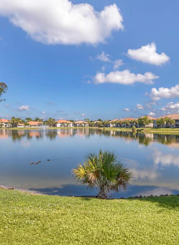 a house with palm trees in front of it at Bay Breeze Villas, Fort Myers, Florida