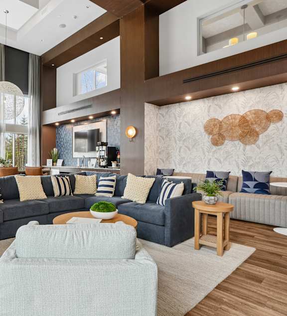 A modern living room with a grey sofa and a wooden coffee table.