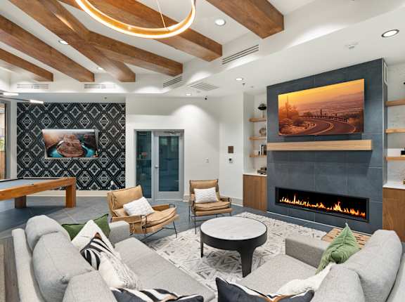 A modern living room with a fireplace and a painting on the wall.