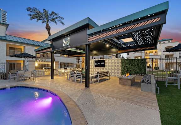 A poolside area with a bar and seating area.
