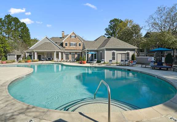 A large house with a pool in front.