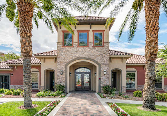 a home with palm trees in front of it