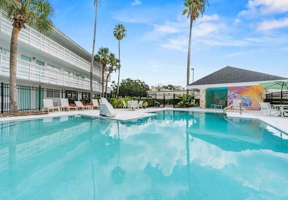 A swimming pool with a mural on the wall at The Teale, Kissimmee, FL, 34746