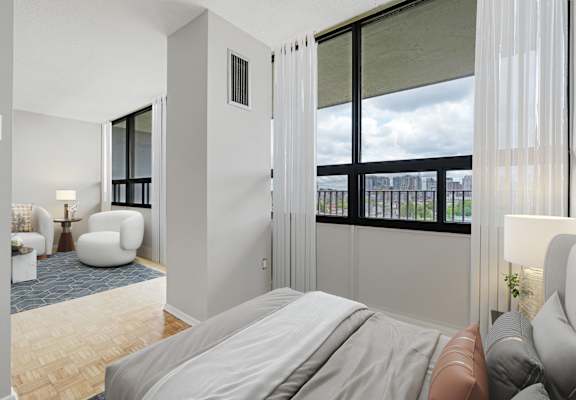 A bedroom with a large bed and a view of the city.