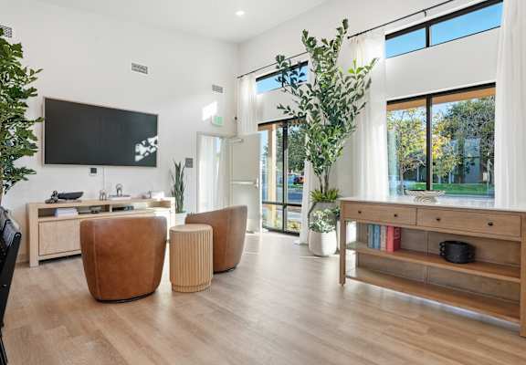 A modern living room with a flat screen TV mounted on the wall.