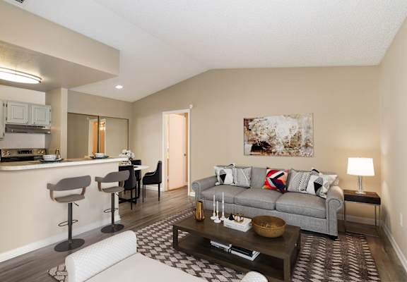 a living room with a couch and a coffee table at Aqua Bay Apartments in Naples, FL 34116