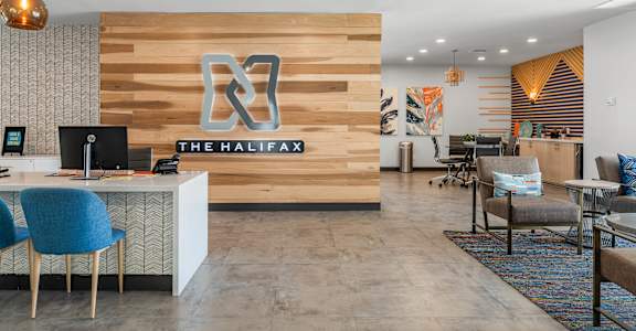 A reception area with a wooden wall and a sign that says "The Halifax".