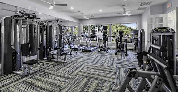 A well-equipped gym with a variety of machines and weightlifting equipment.