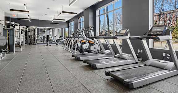 A gym with treadmills and other exercise equipment.