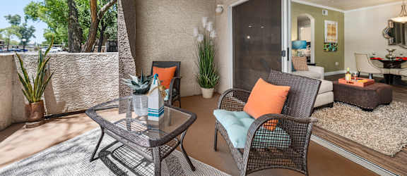 A patio with a chair and a table.