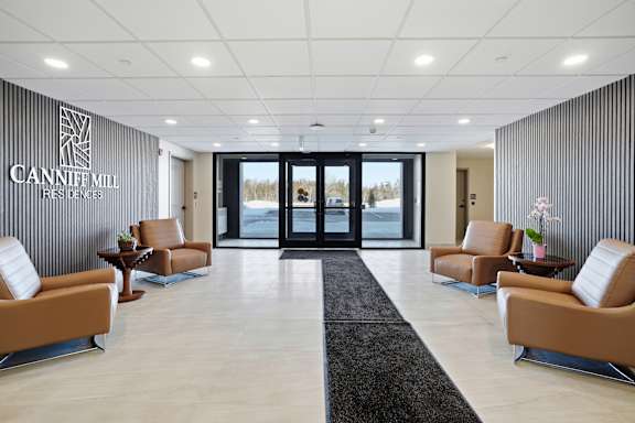 A reception area with chairs and a sign that says Cannife Mill.
