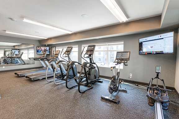 A gym with treadmills and exercise bikes.