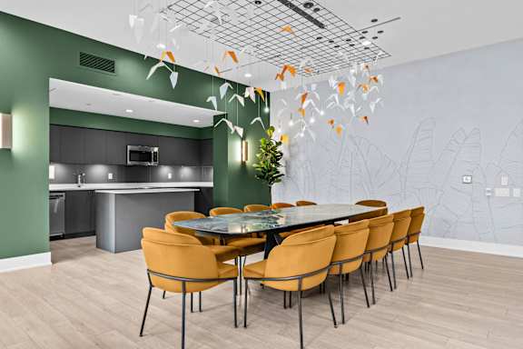 A modern dining room with a large table and chairs.