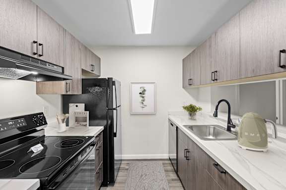 a bedroom with a bed and a ceiling fan at The Northway at Clifton Park Apartments, Clifton Park