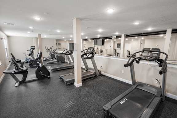 A gym with treadmills and elliptical machines.