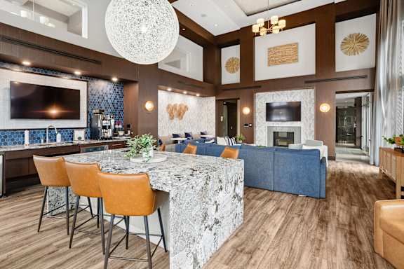 A modern kitchen with a bar area and a dining table.