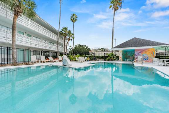 A swimming pool with a mural on the wall at The Teale, Kissimmee, FL, 34746