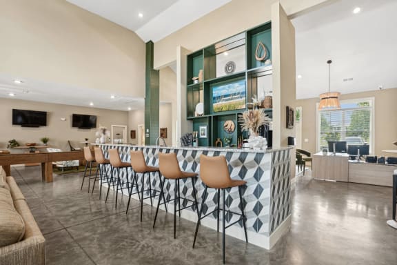 a large lobby with a bar and a living room with furniture