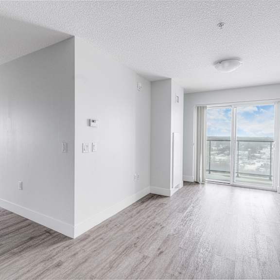 A long hallway with doors on both sides and a carpet on the floor.