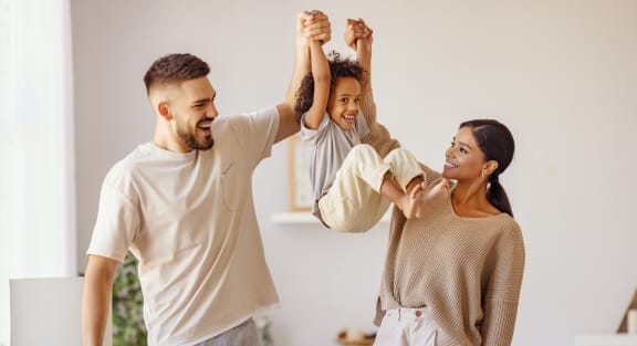 Young Family Playing with Their Daughter