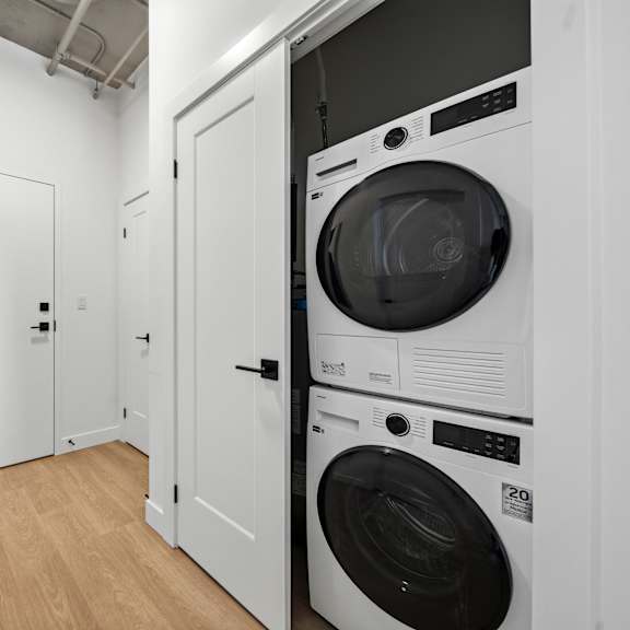 White Laundry Room with Front Loading Machines at Richmond Square, London, N6A 5M8