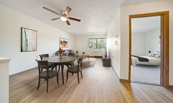 A dining room with a table and chairs is shown. at Edinlake Apartments, Edinboro