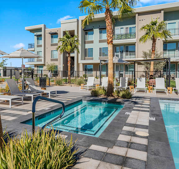 a swimming pool at a hotel with palm trees